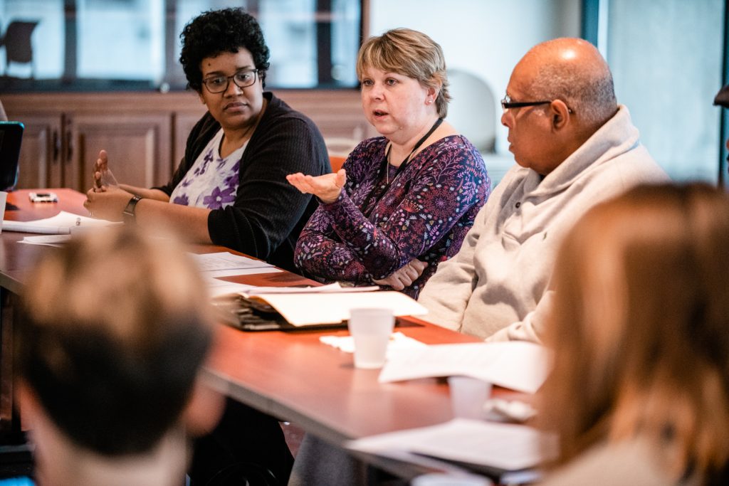 Linda Miller, center, facilitates a monthly meeting with the Truth and Transformation project partners. (Jayme Halbritter)