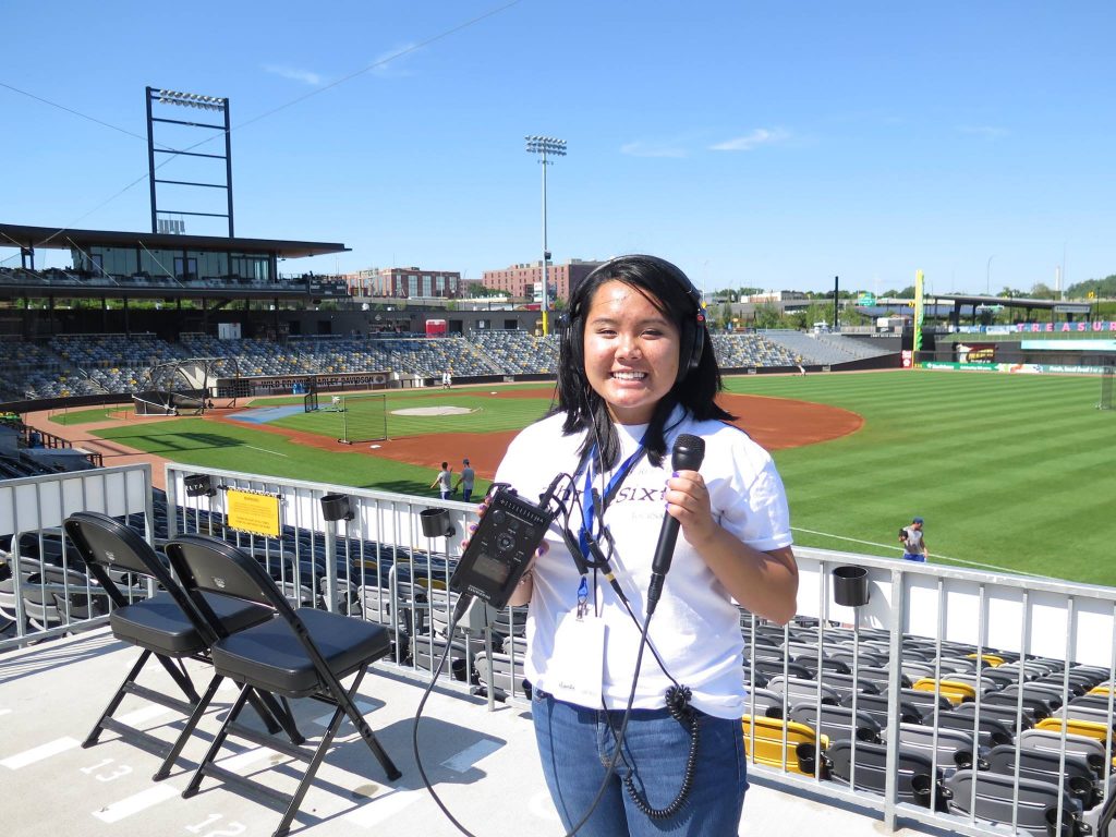 A student holds recording equipment at CHS Field during ThreeSixty's 2018 Radio Camp