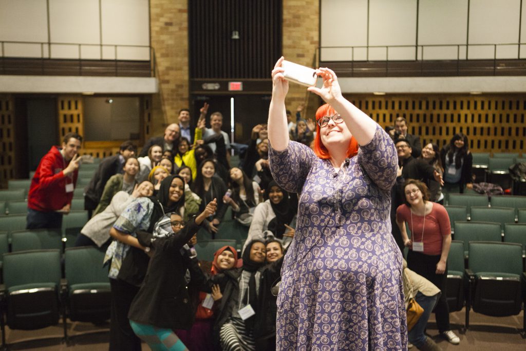 Erica Hanna, owner of Puke Rainbows Creative, takes a photo of the students at the Three Sixty Journalism Youth Social Media Summit in O'Shaughnessy Educational Center Auditorium on Saturday, February 27, 2016.