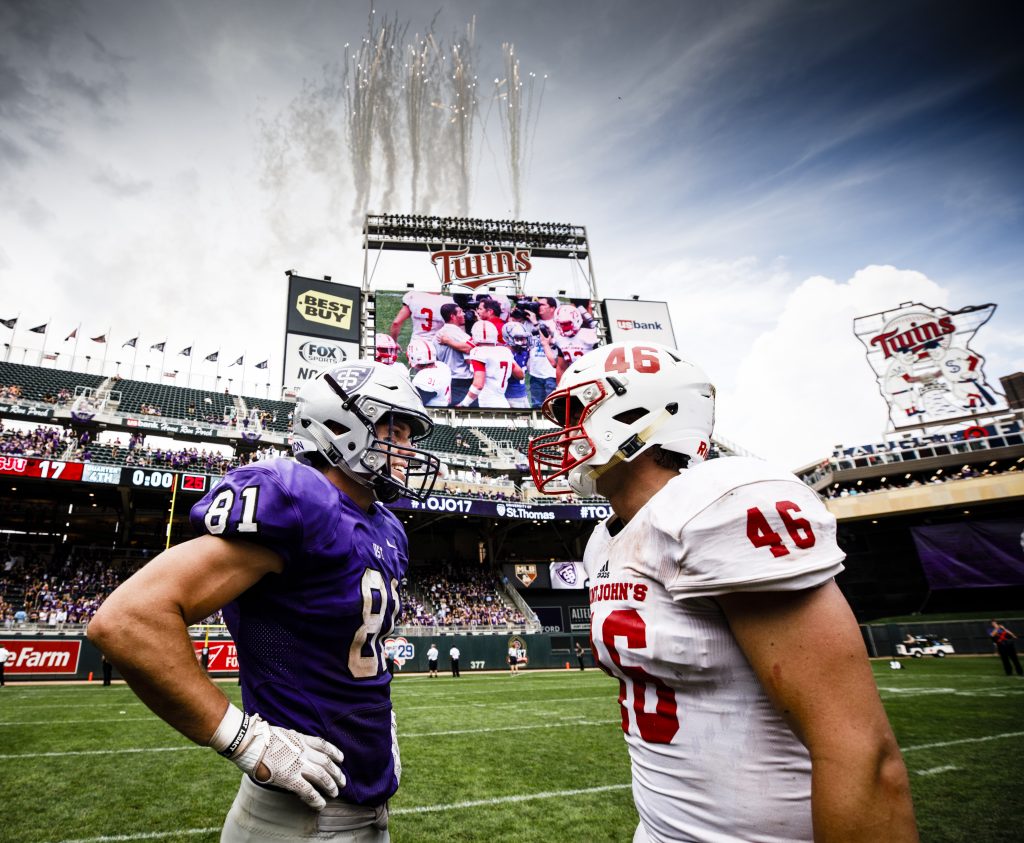 Grant Slavik (81) stands with Saint John's player Trevor Dittberner following the Tommie Johnnie football game at Target Field in Minneapolis on September 23, 2017. The University of St. Thomas defeated Saint John's University by a final score of 20-17.