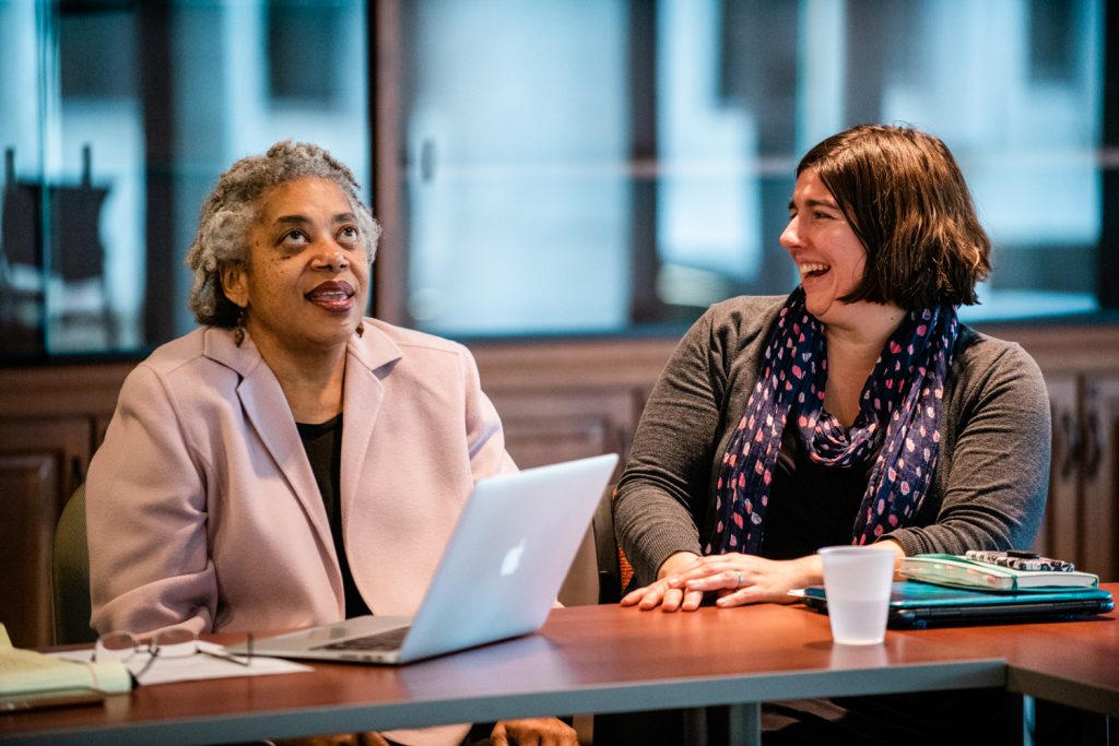 Jane Turk, Hamline instructor and high-impact learning practices coordinator in the Center for Teaching and Learning, with Karen Gray at a Truth and Transformation Steering Committee meeting. (Jayme Halbritter)