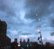 photo of a city scape at late afternoon/night with dark clouds in the sky