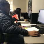 Cristo Rey student DeTerrio Morman Jr. works on his essay at Boot Camp.
