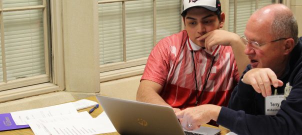 Cristo Rey Jesuit High School student Marco Beltran Galan works with writing coach Terry Wolkerstorfer on his college essay.
