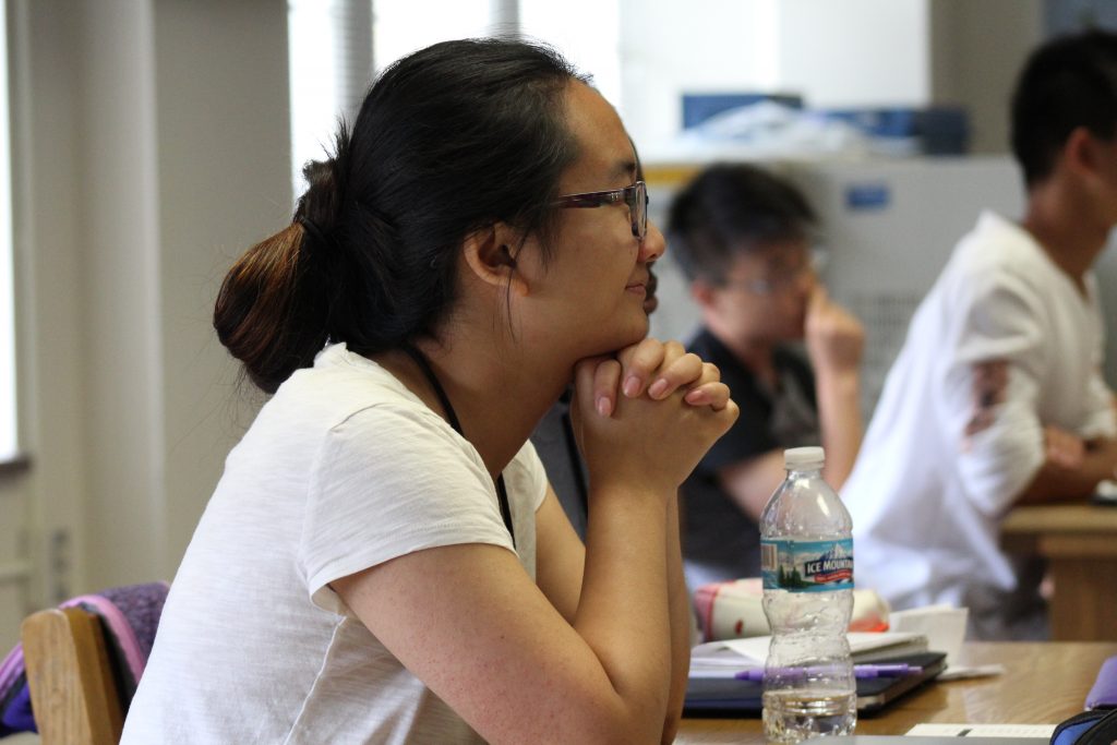News Reporter Academy camper Tristan Xiong listens to interview tips from Star Tribune TV Critic Neal Justin.