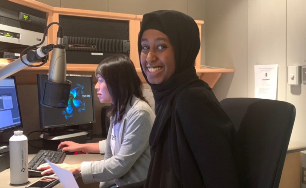 ThreeSixty's Safiya Mohamed edits her radio story with the help of MPR News Editor Laura Yuen at Radio Camp.